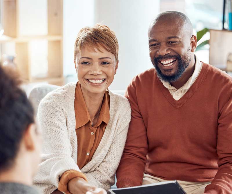 Happy couple meeting with consultant